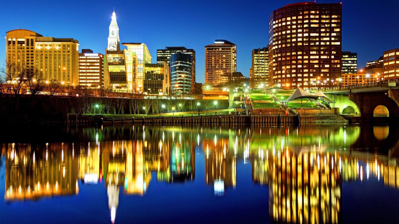 hartford CT Night Downtown Hartford Connecticut skyline at night with city lights reflecting on the Connecticut River